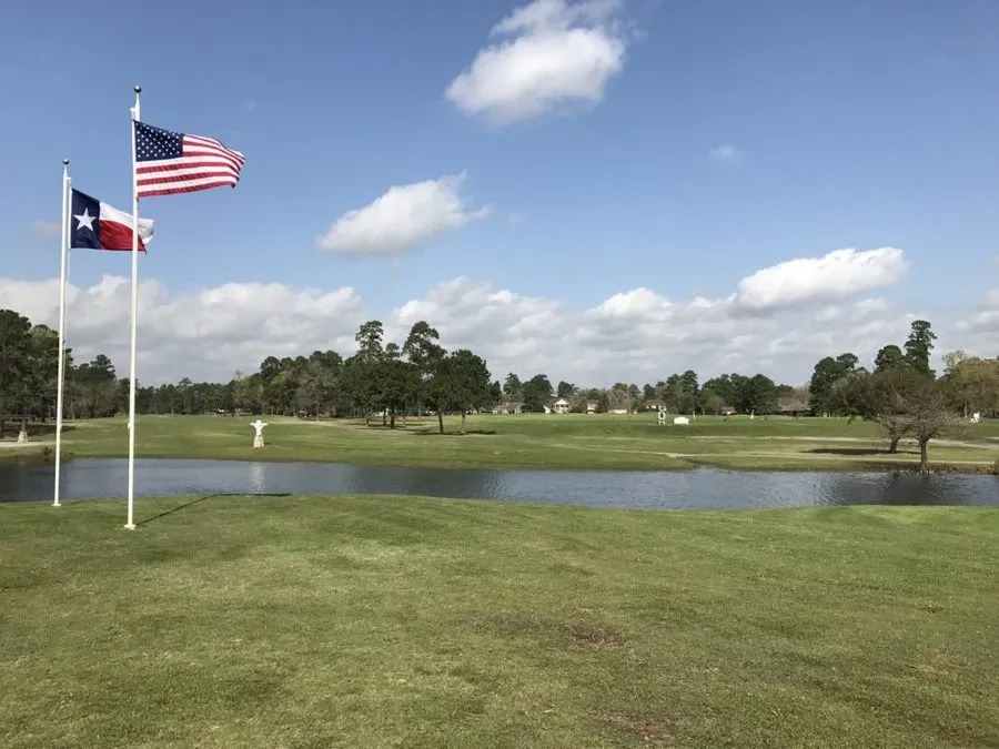 USA and Texas flags fly over the course and water.