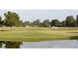 Smooth water with fairways in the background.